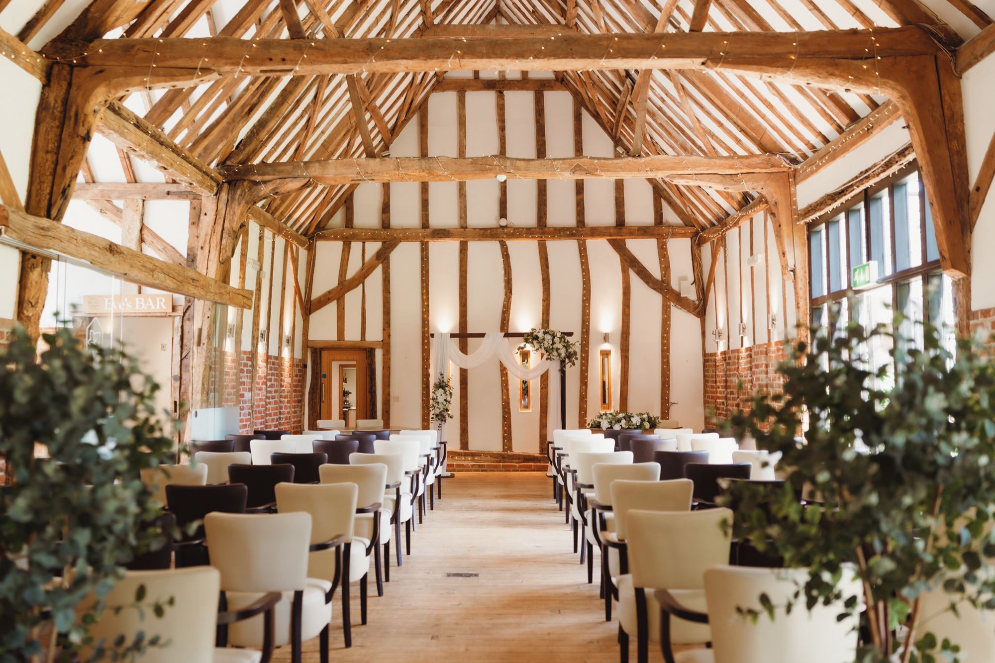 Inside the oak beamed Crooked Barn set for a ceremony