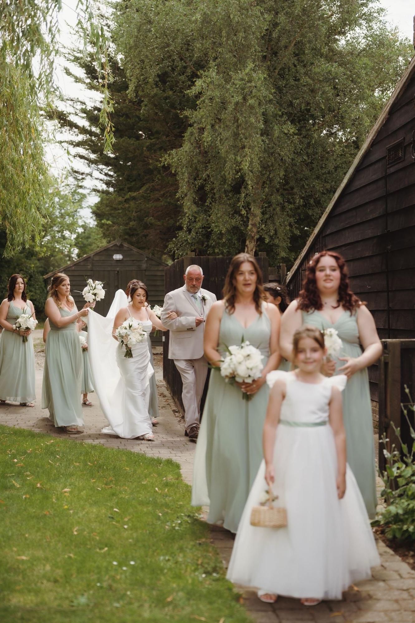 A bride walks down the aisle in the barn