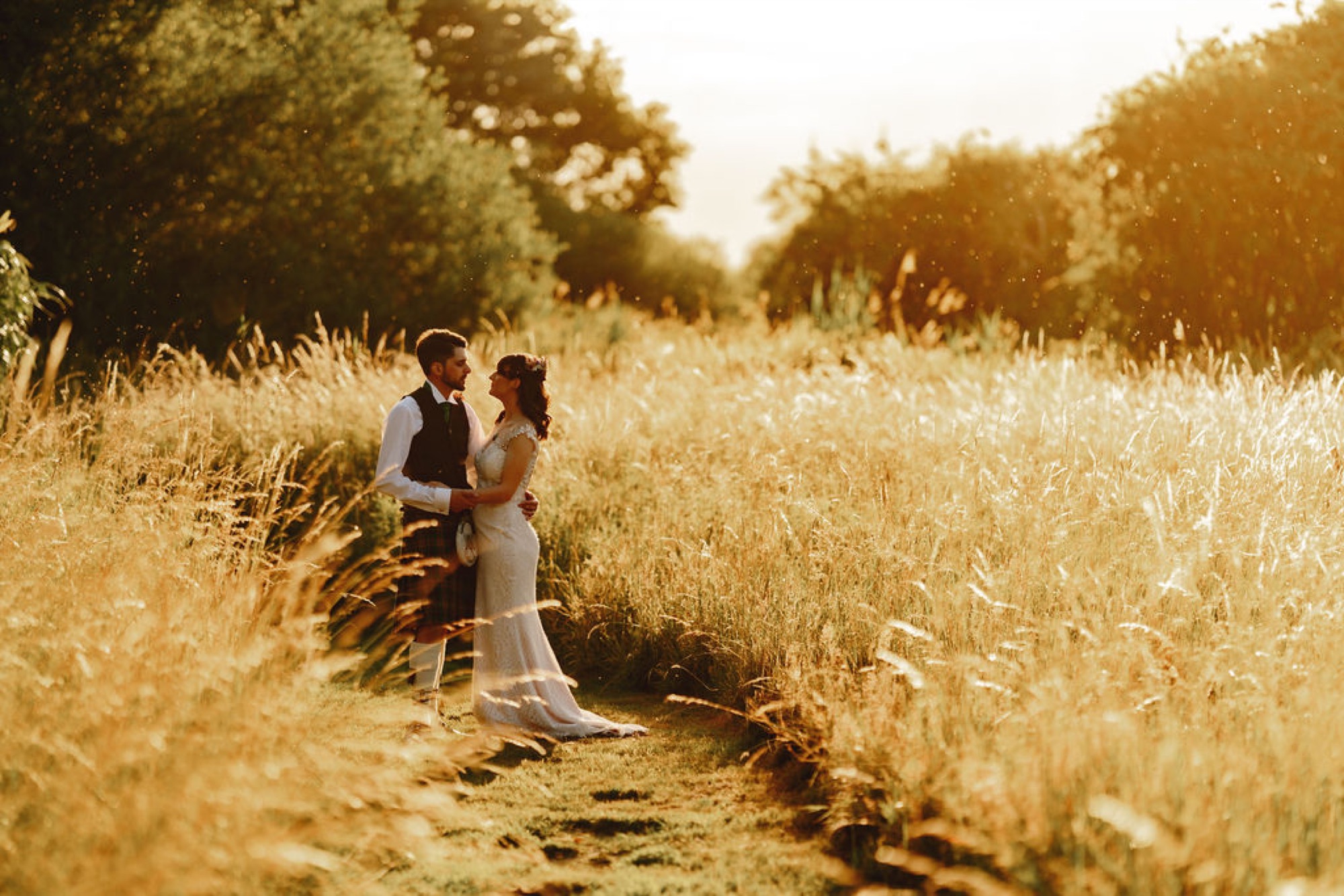 A newly married couple in the gardens at golden hour