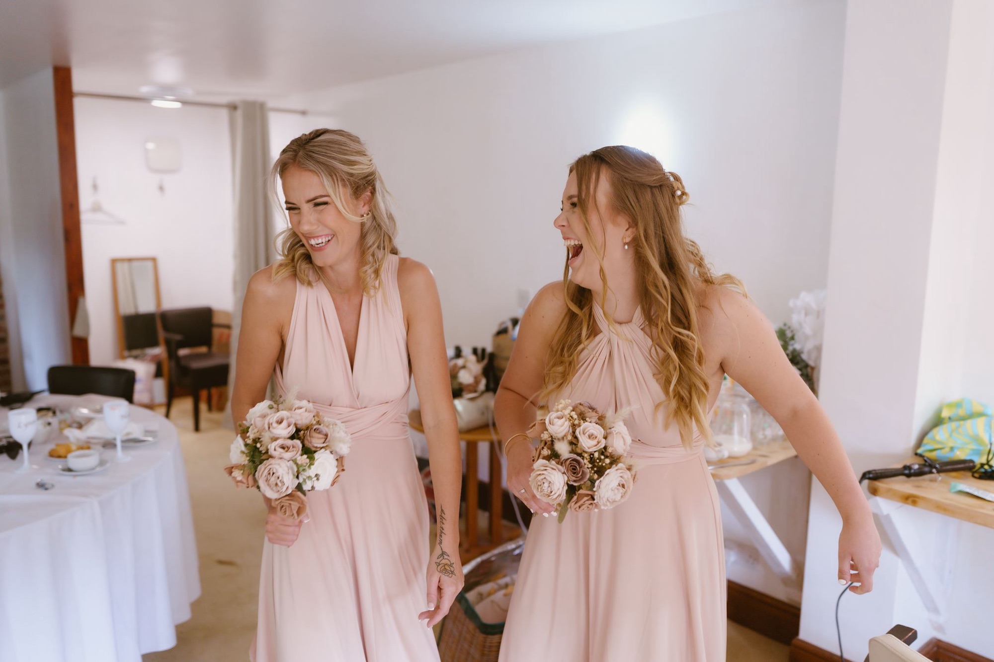 Bridesmaids laughing together before the ceremony