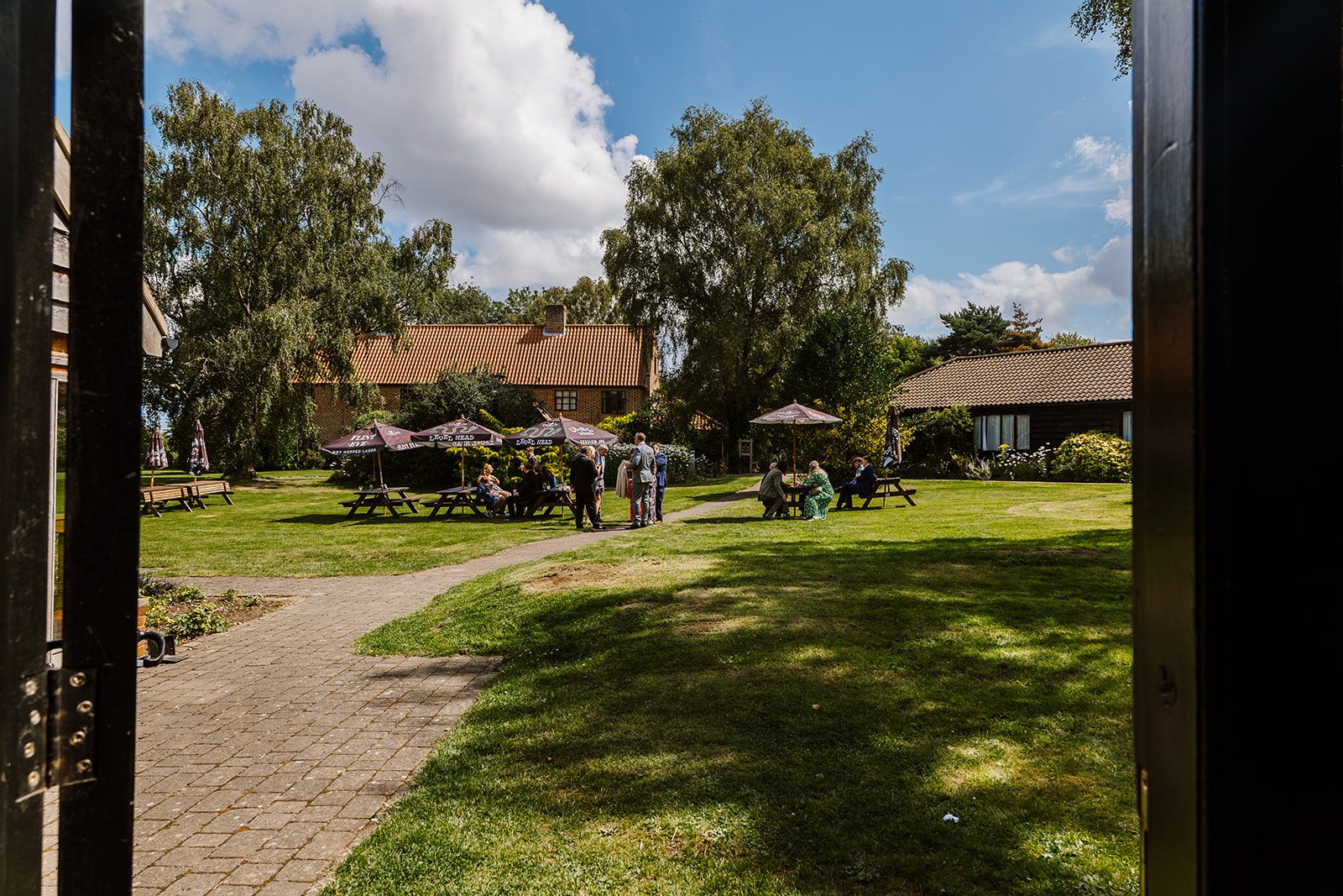 The gardens and accommodation buildings at Ivy House on a sunny day