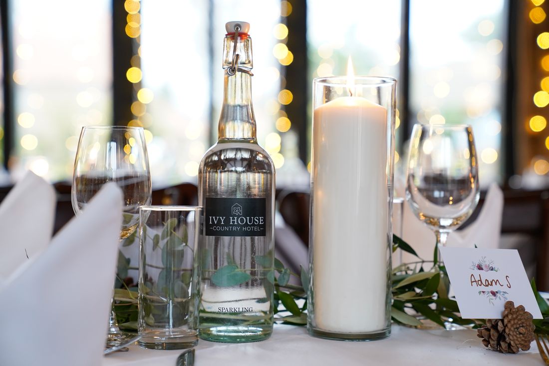 Chilled fizz and candles set on a dressed table